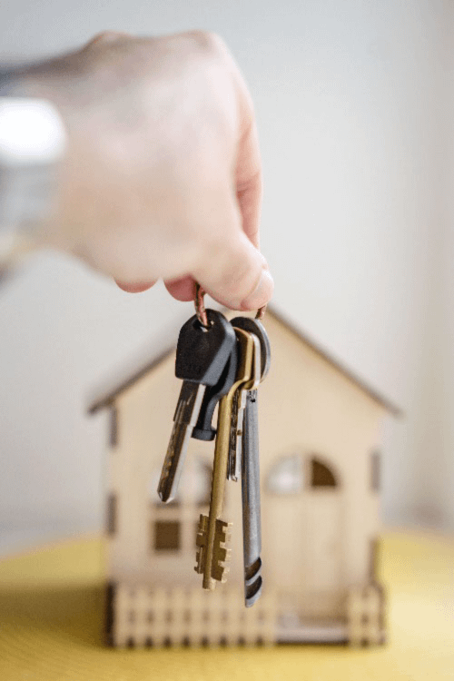 Keys in front of a model house